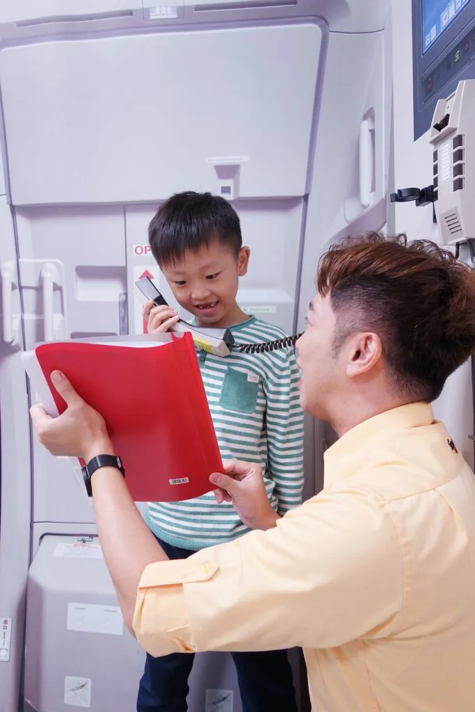 Parent-kid cabin crew camp: in flight announcement and safety check